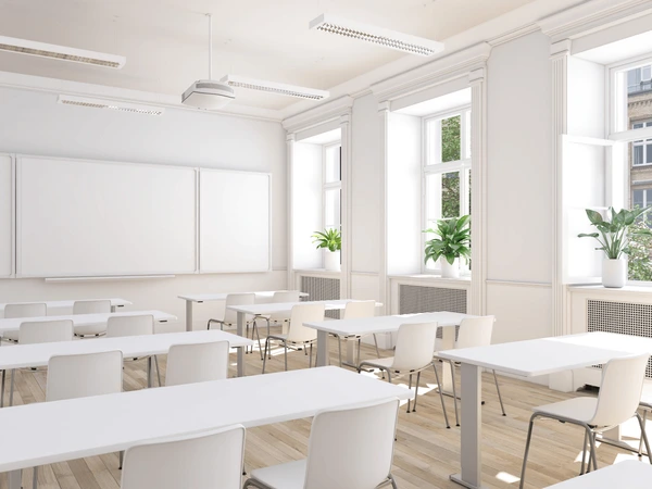 Crystal Clear team professionally cleaning school classroom with desks and educational displays